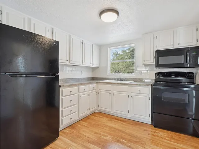 a kitchen with a refrigerator stove and microwave