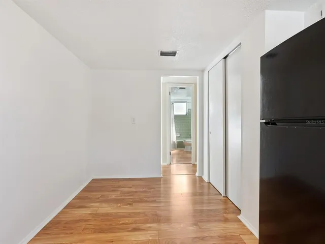 a view of a room with wooden floor