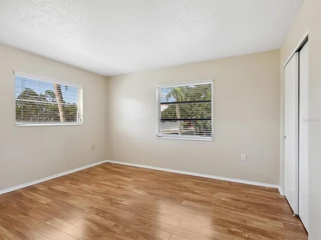 a view of a room with wooden floor and window