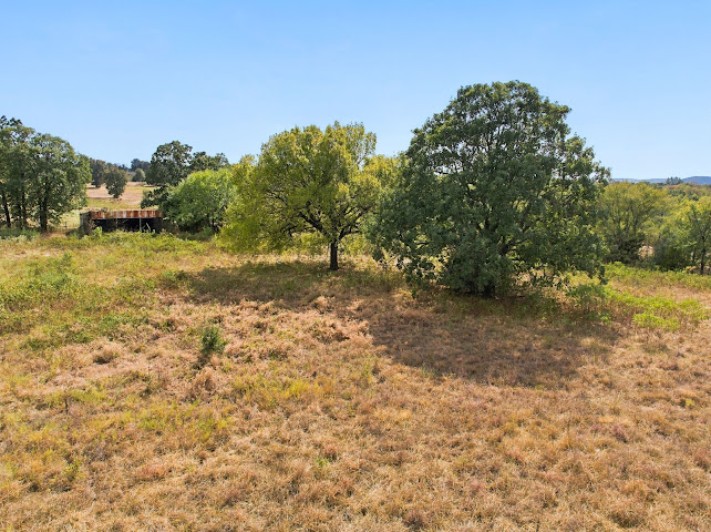 30063 South 4300th Road Stigler, OK 74462 - Photo 58 of 58 Expansive natural landscape with mature trees and a distant structural element