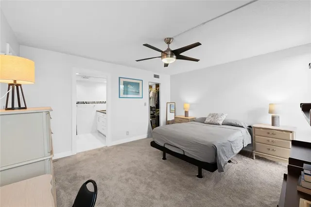 a bedroom with a bed and a lamp on table