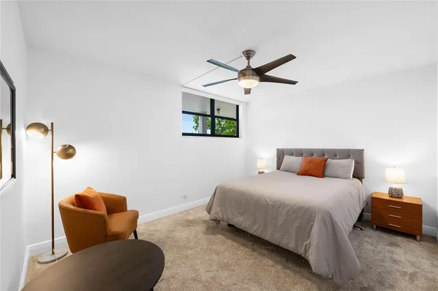 a bedroom with furniture and a ceiling fan