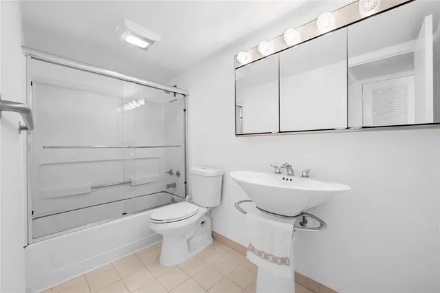a view of a balcony with chairs and a potted plant