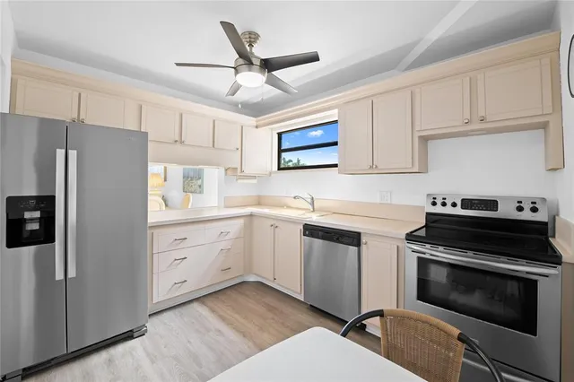 a kitchen with cabinets stainless steel appliances and a counter space