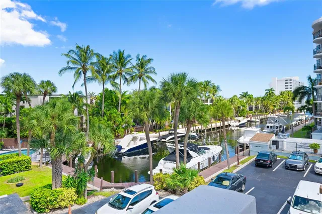 a balcony with wooden floor table and chairs