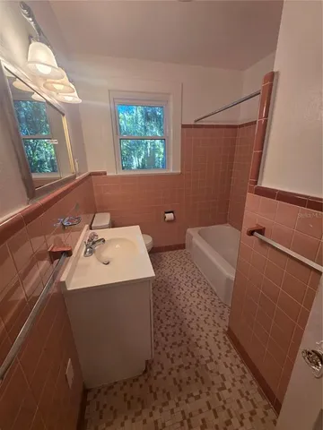 a bathroom with a sink a toilet and a shower