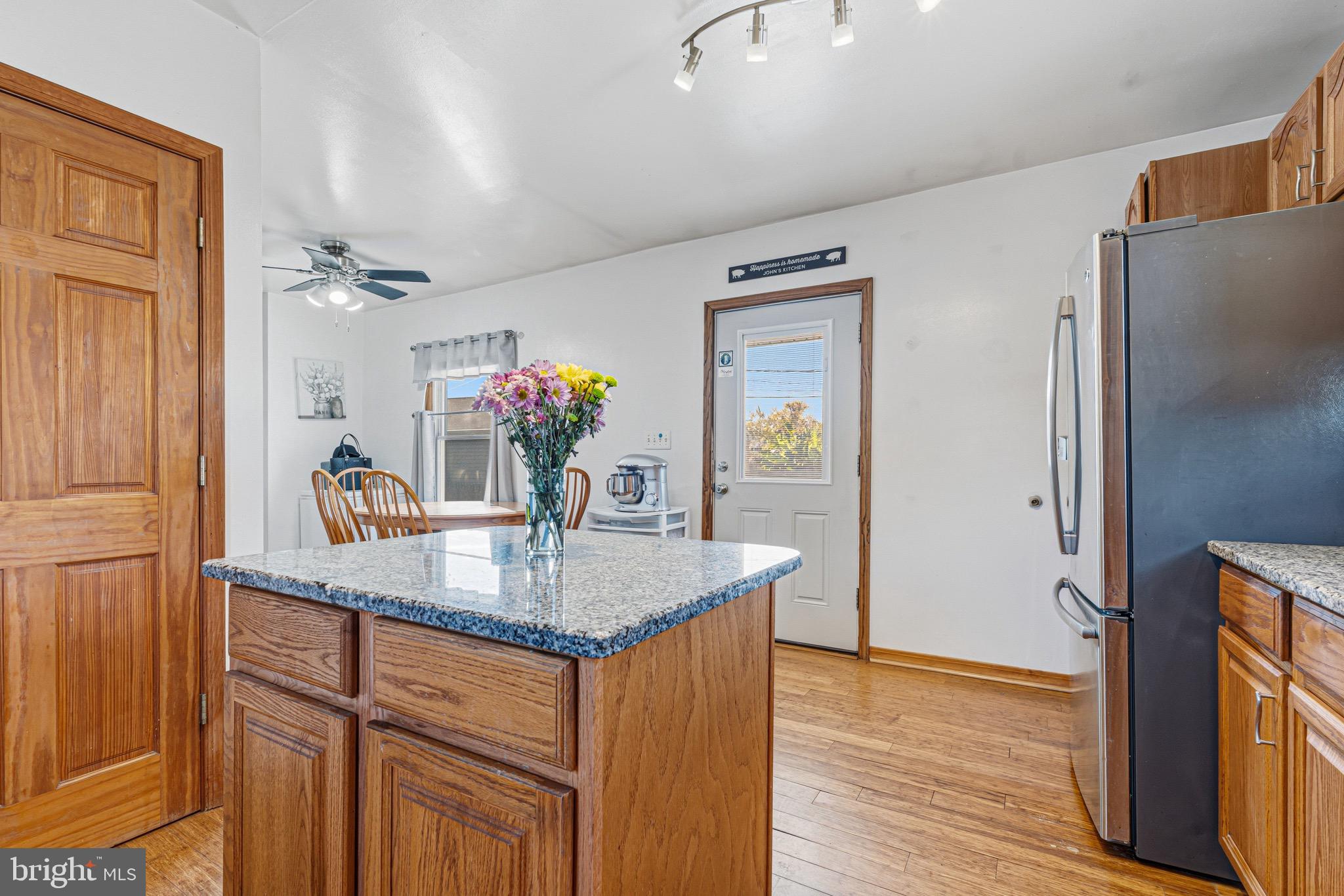 1907 Wills Road Baltimore, MD 21222 - Photo 9 of 42 a view of kitchen island cabinets furniture and wooden floor