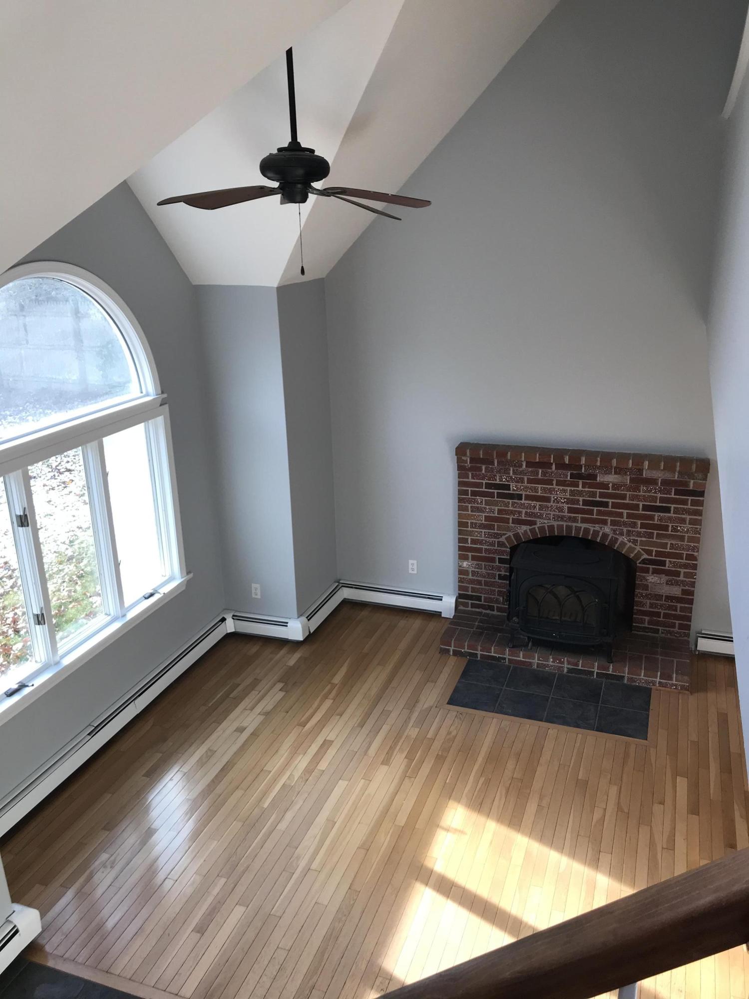 57 Deer Ridge Road Mashpee, MA 02649 - Photo 14 of 18 wooden floor fireplace and windows in an empty room