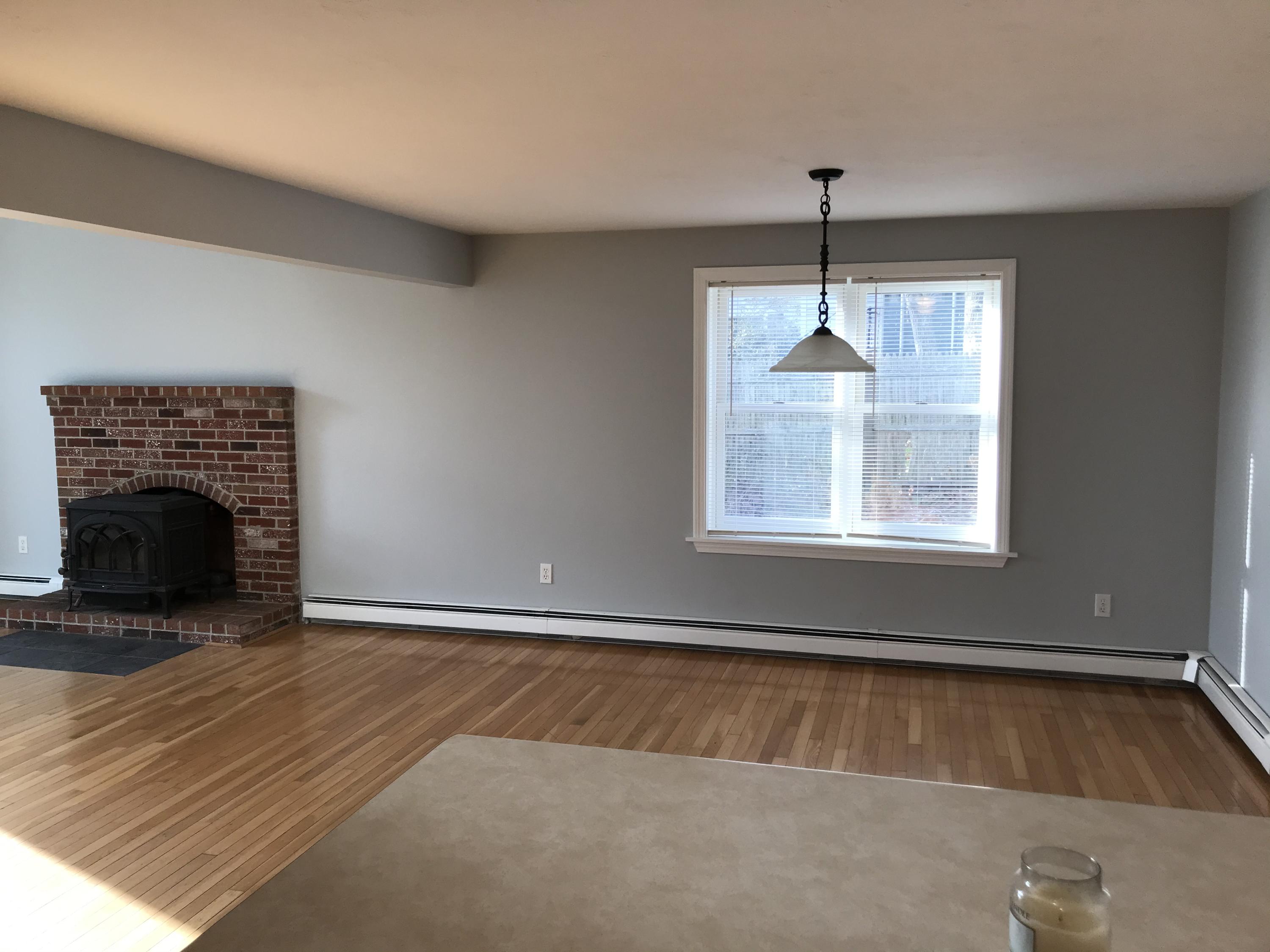57 Deer Ridge Road Mashpee, MA 02649 - Photo 17 of 18 a view of an empty room with wooden floor fireplace and a window