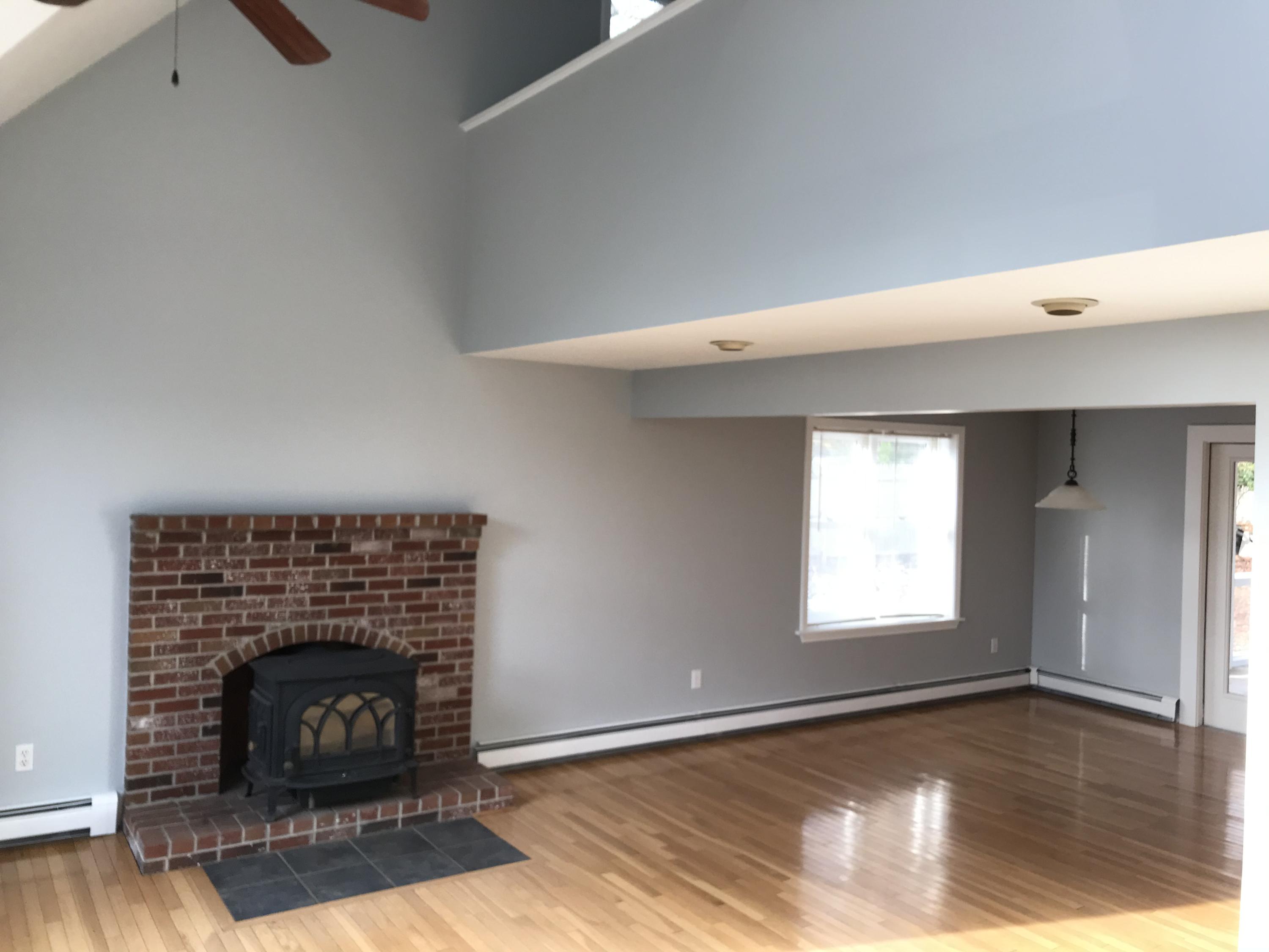 57 Deer Ridge Road Mashpee, MA 02649 - Photo 4 of 18 a living room with a fireplace and wooden floor