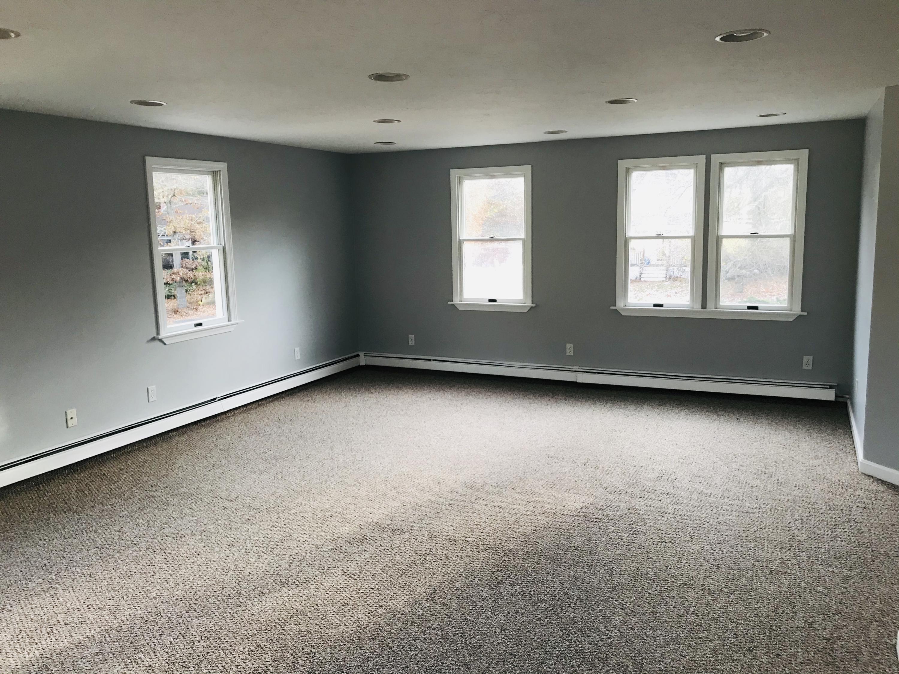57 Deer Ridge Road Mashpee, MA 02649 - Photo 7 of 18 an empty room with windows