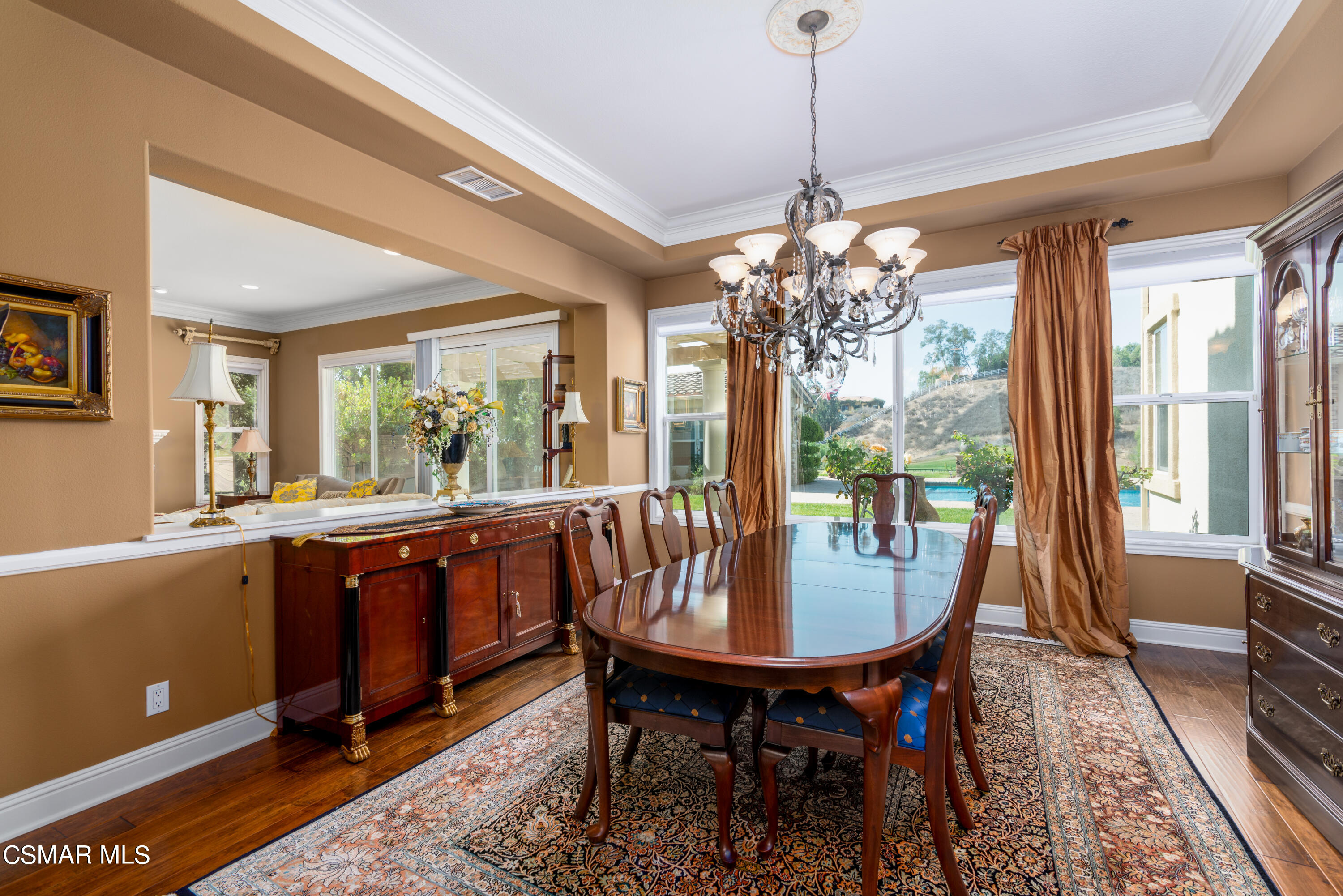 12442 Nelson Road Moorpark, CA 93021 - Photo 33 of 83 a dining room with furniture a chandelier and wooden floor