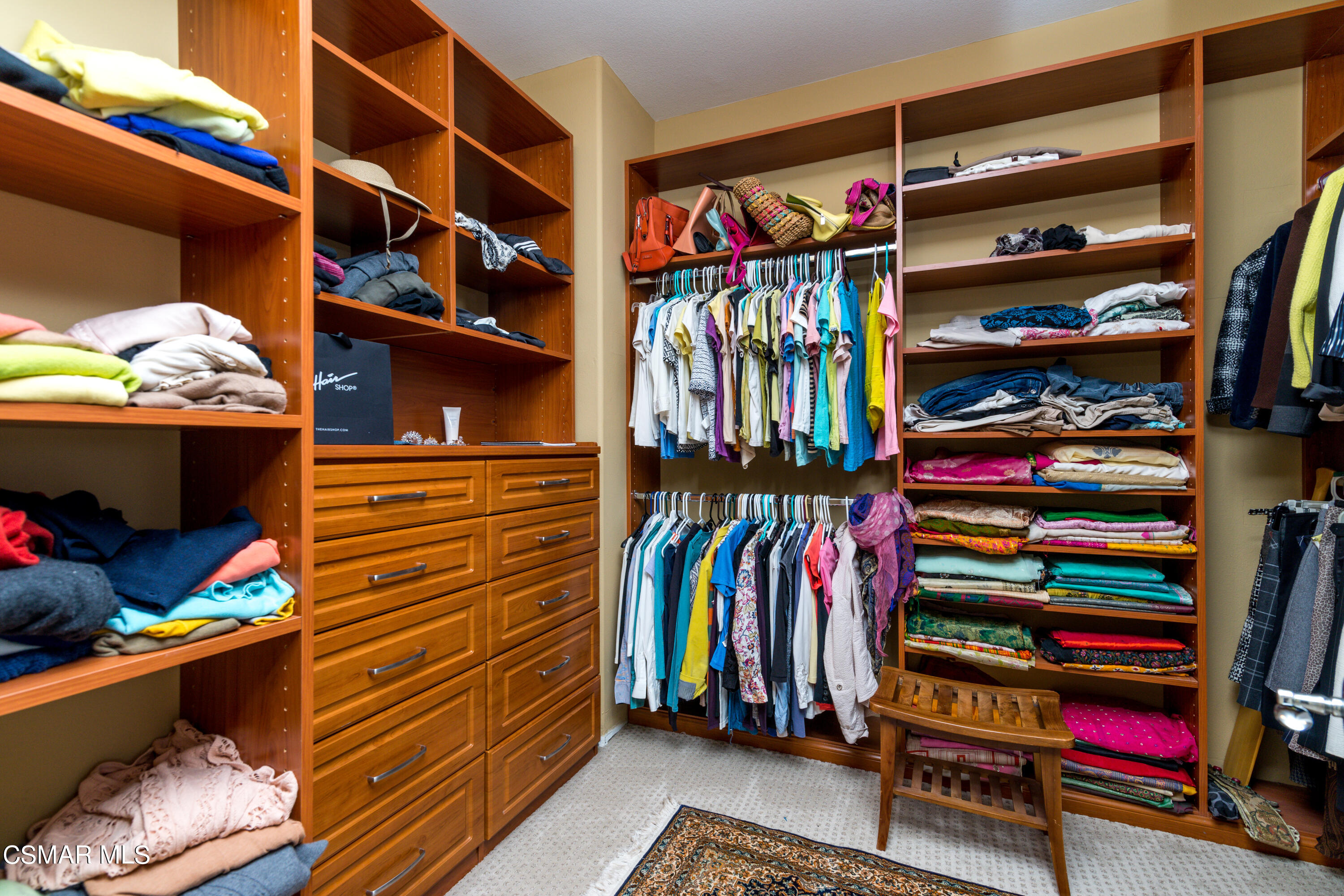 12442 Nelson Road Moorpark, CA 93021 - Photo 54 of 83 a view of walk in closet with clothes and shoes