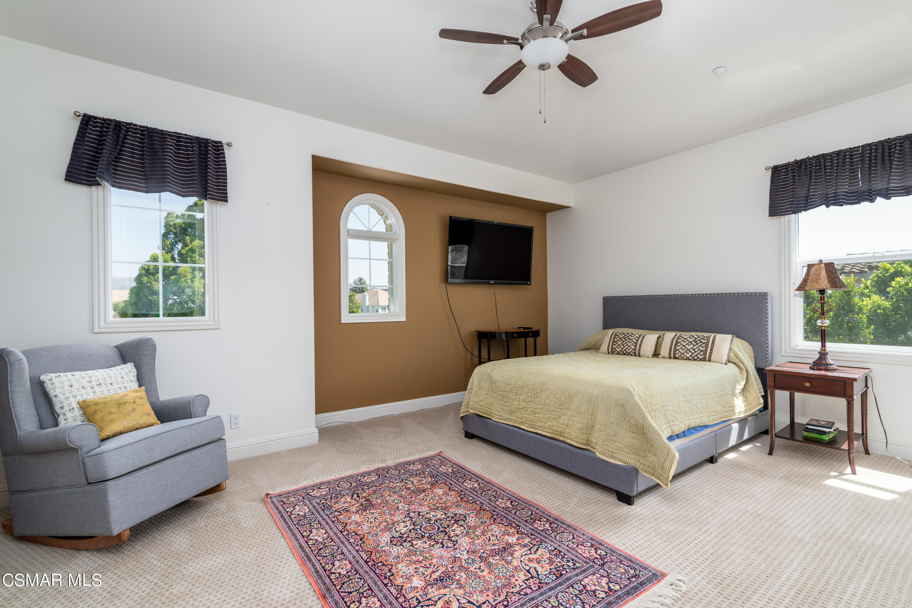 12442 Nelson Road Moorpark, CA 93021 - Photo 67 of 83 a spacious bedroom with a bed a couch and a flat screen tv