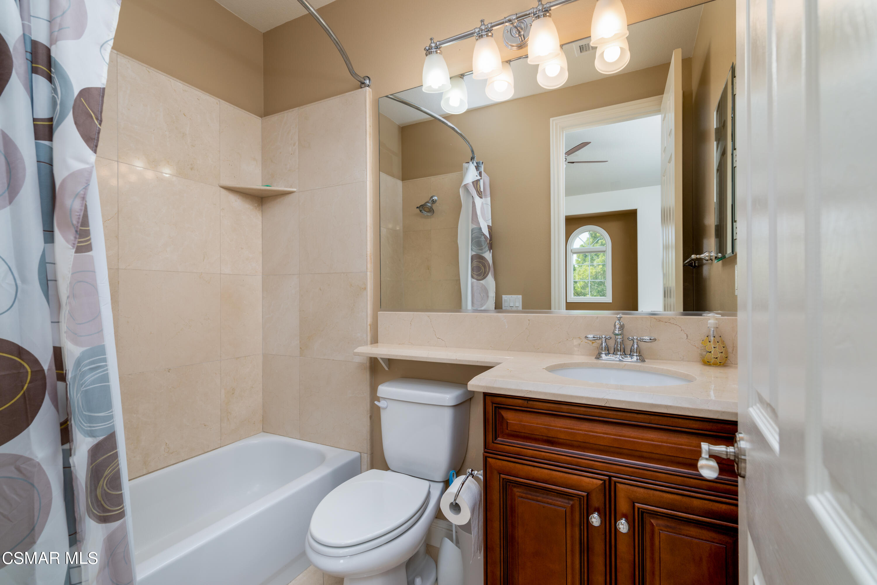 12442 Nelson Road Moorpark, CA 93021 - Photo 68 of 83 a bathroom with a sink a toilet a mirror a vanity and bathtub