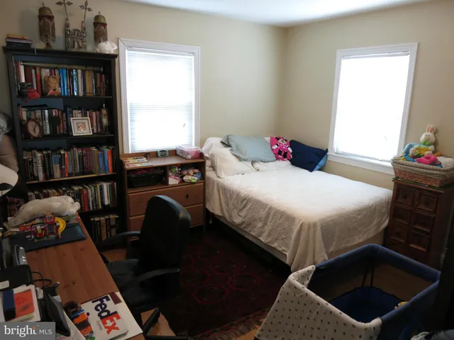 a bedroom with a bed furniture and a book shelf