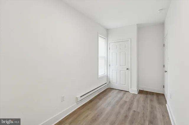 a view of a room with wooden floor