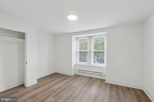 a view of a livingroom with wooden floor and window