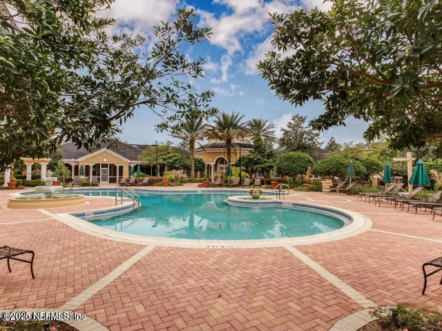 a view of a swimming pool with an outdoor space and seating area
