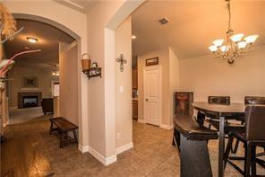 1409 Rosson Road Little Elm, TX 75068 - Photo 4 of 34 Tiled flooring with an arched entryway leading to a living space featuring a fireplace