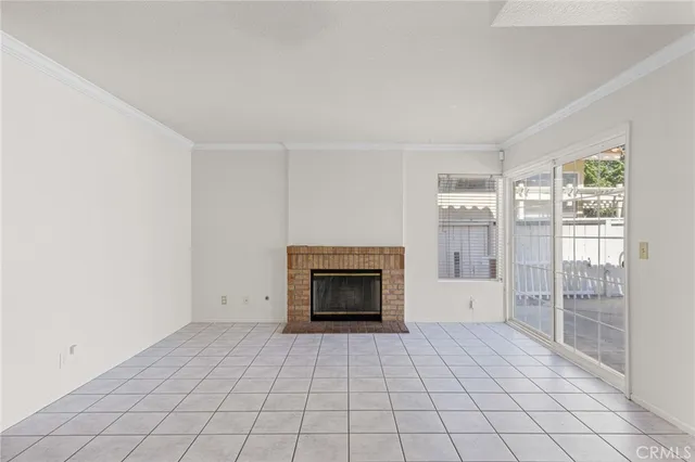 a view of empty room with cabinet and windows