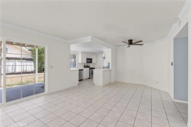 a view of a kitchen with microwave and refrigerator