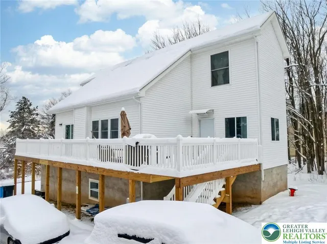 a bathroom with double vanity a sink and a large mirror