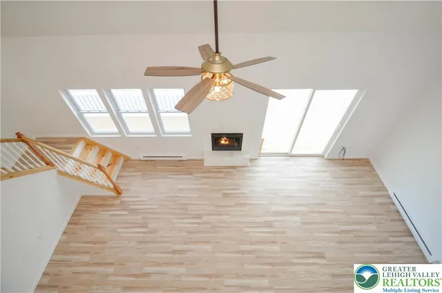 a view of a livingroom with a ceiling fan and window