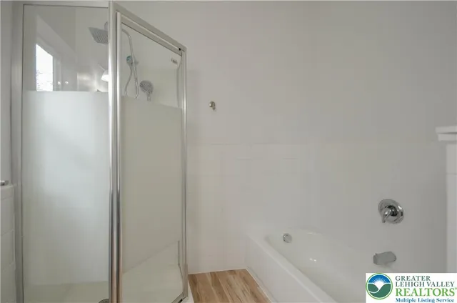 a bathroom with a bathtub and shower