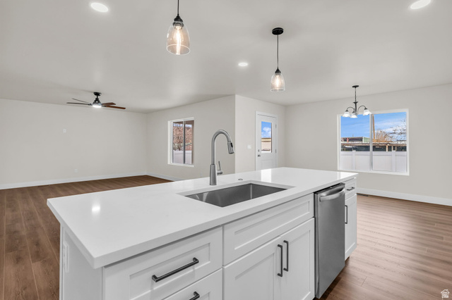 578 West 7th Midvale, UT 84047 - Photo 35 of 35 Kitchen featuring dark wood-style floors, white cabinets, stainless steel dishwasher, open floor plan, and an island with sink