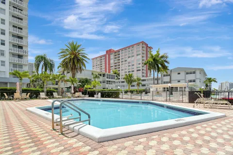 a view of a building with potted plants in front of door