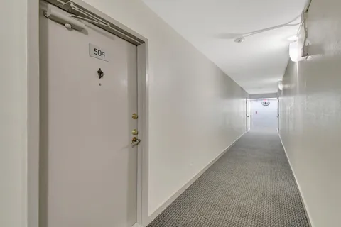 a kitchen with stainless steel appliances a sink a stove a refrigerator and cabinets