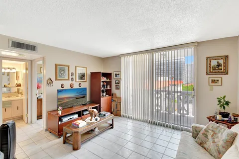 a bedroom with a bed and a potted plant