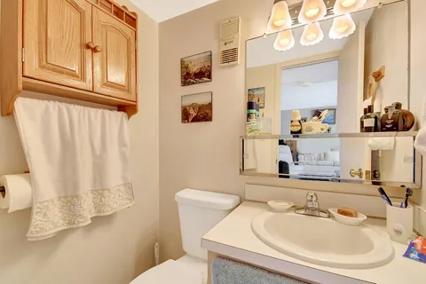 a bathroom with a sink mirror and vanity