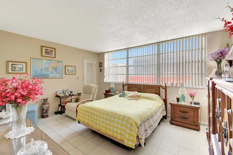 a bathroom with a toilet a sink and a shower curtain