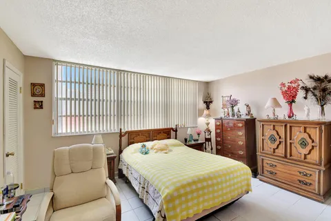 a view of a patio with couches table and chairs and potted plants