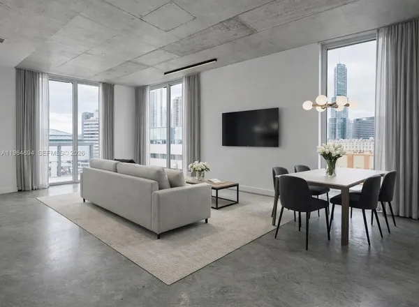 a spacious bedroom with a bed and a flat screen tv
