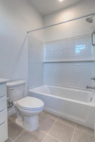 a bathroom with a toilet and a bathtub