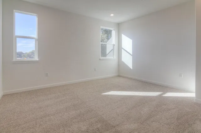 an empty room with windows and closet