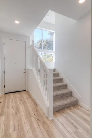 a view of an entryway with wooden floor