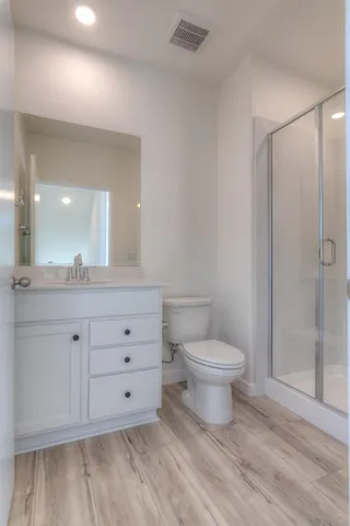 a bathroom with a toilet a sink and shower