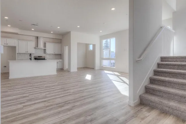 a view of a kitchen with wooden floors and kitchen view