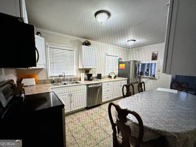 a kitchen with granite countertop lots of counter top space and stainless steel appliances