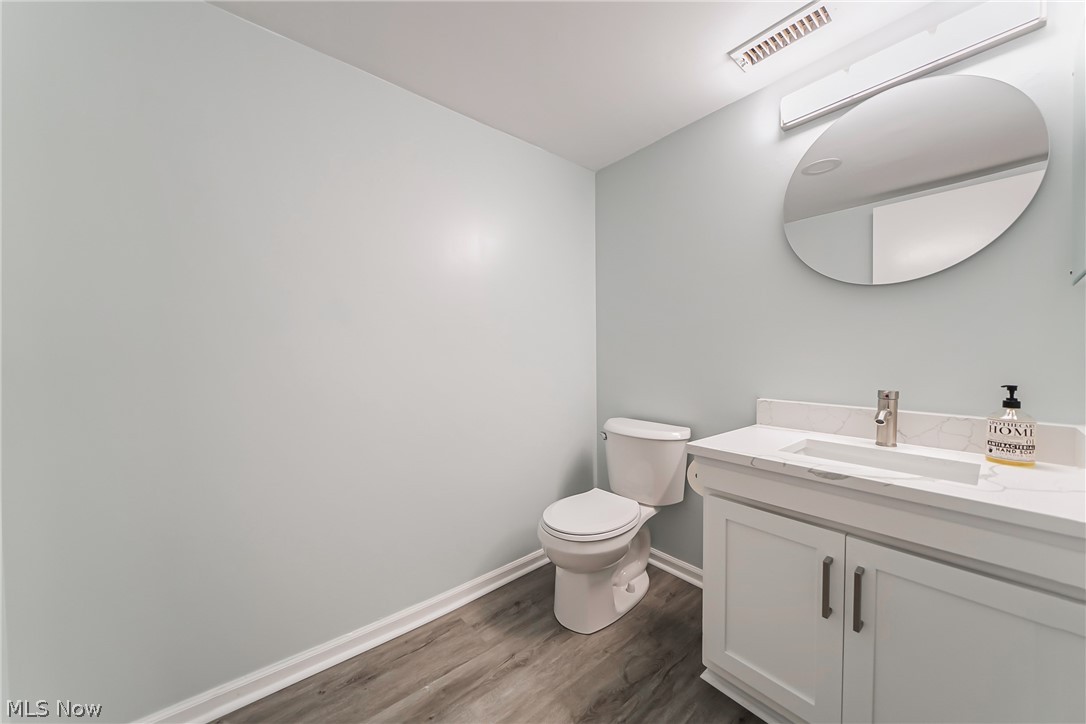 22701 Center Ridge Road, Unit 304 Rocky River, OH 44116 - Photo 25 of 31 Bathroom featuring vanity, wood-type flooring, and toilet