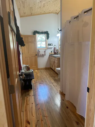 a bedroom with a bed dresser and a window