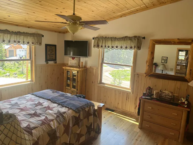 a bedroom with a bed and window