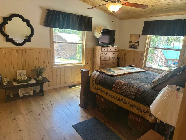 a bed sitting in a room next to a window