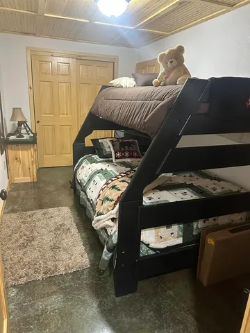 a bedroom with bed and a chandelier