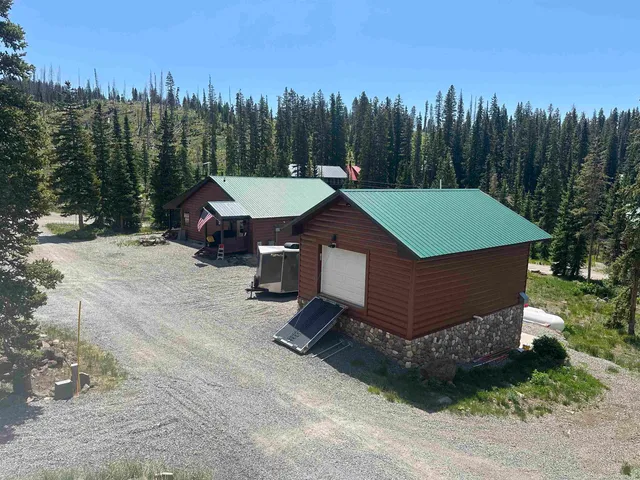 a view of a chairs and table in the back yard
