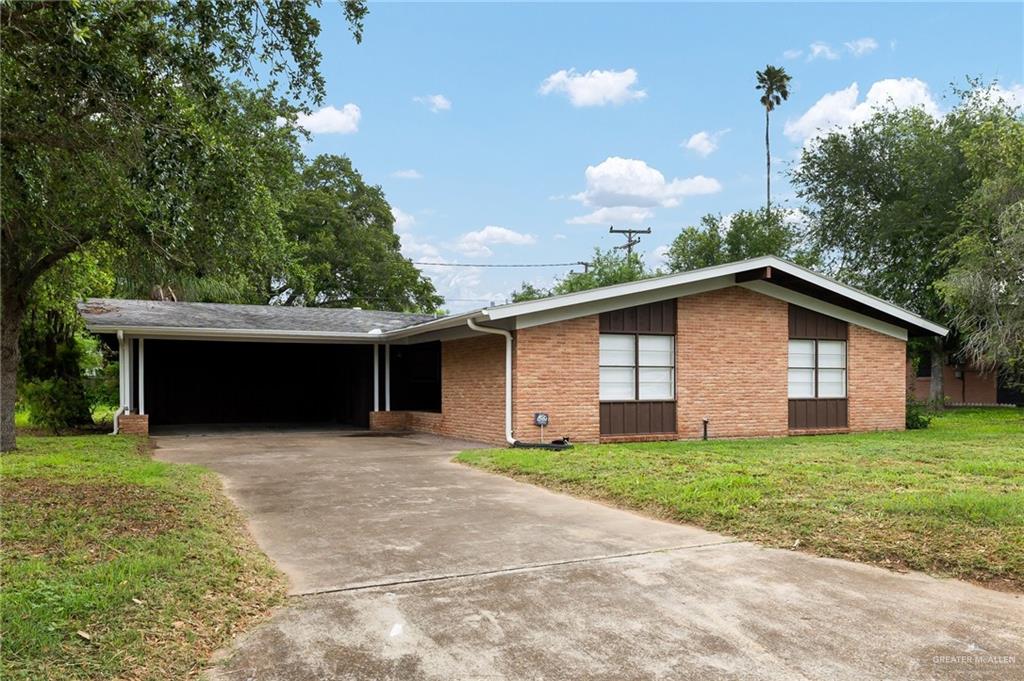 904 West 8th Street Weslaco, TX 78596 - Photo 1 of 1 a view of a house with a yard and garage